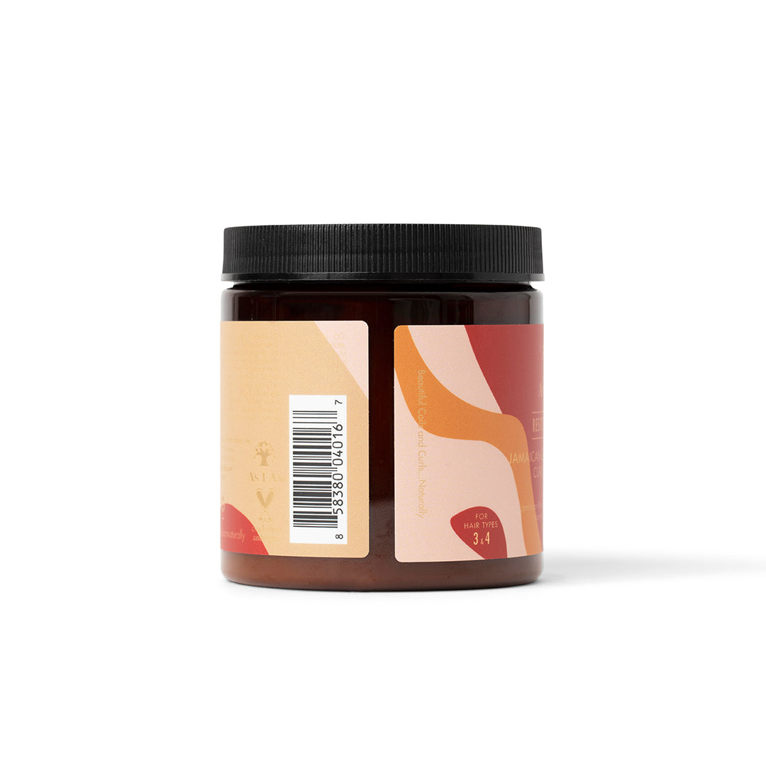 Siden af en mørk beholder As I Am Jamaican Black Castor Oil Curling Creme (227 g) med en beige og lyserød etiket, der viser en stregkode og en del af produktinformationen.