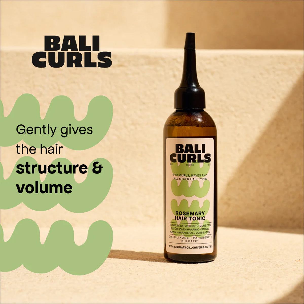 Bottle of BALI CURLS Rosemary Hair Tonic placed on light stairs, highlights structure and volume for curly hair.