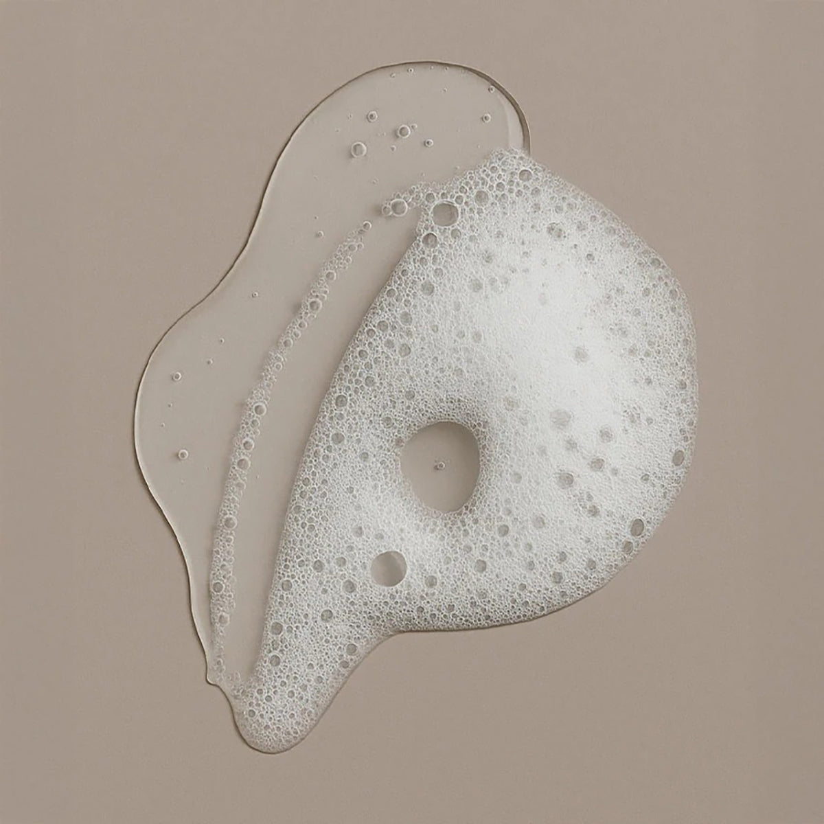 Foaming consistency of Bali Gents Gentle Face & Beard Wash 150ml on a beige background with transparent gel and fine bubbles.