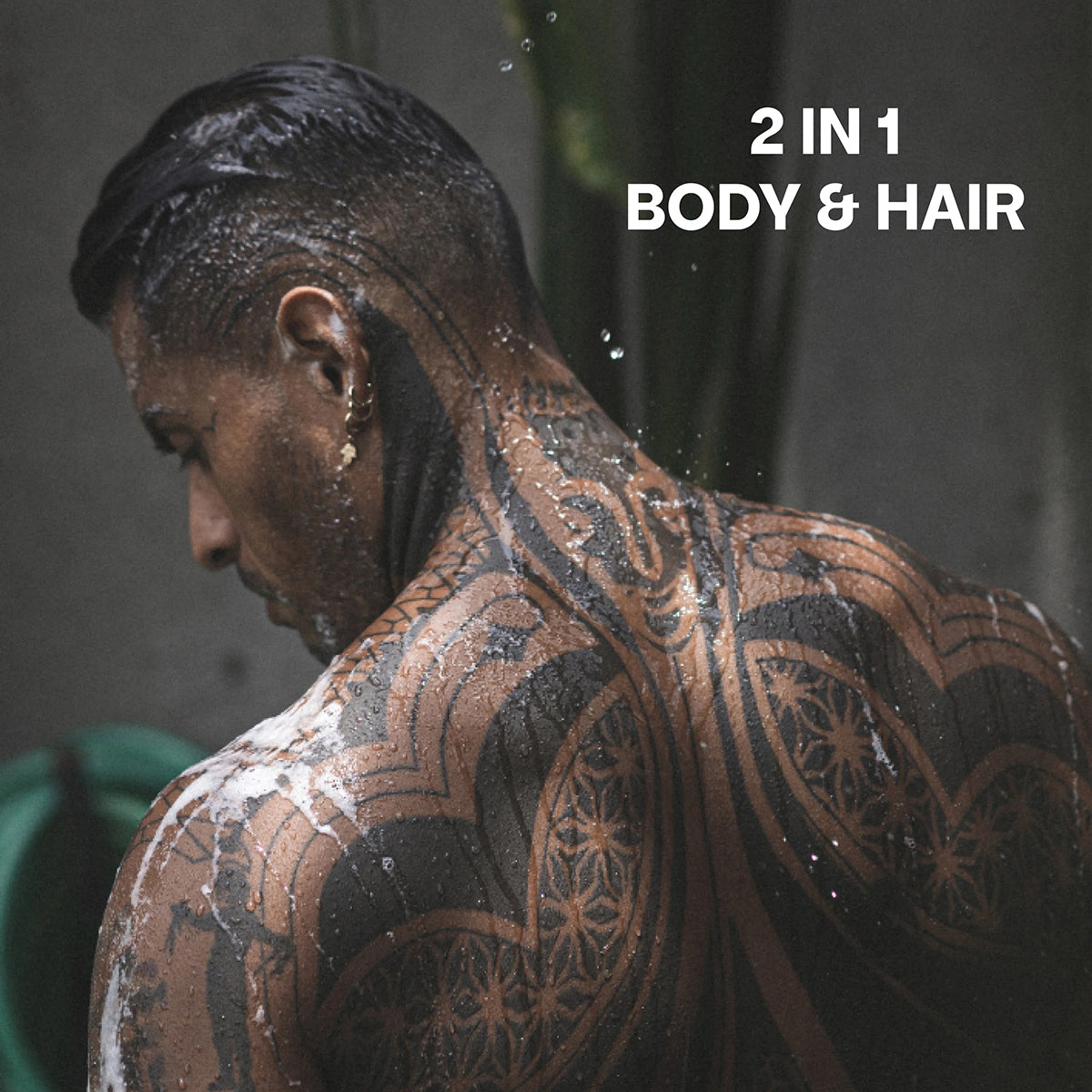 Men with wet tattoos use Bali Gents Shower Gel Rosemary Ginger 1 200ml in the shower, 2-in-1 for body and hair.