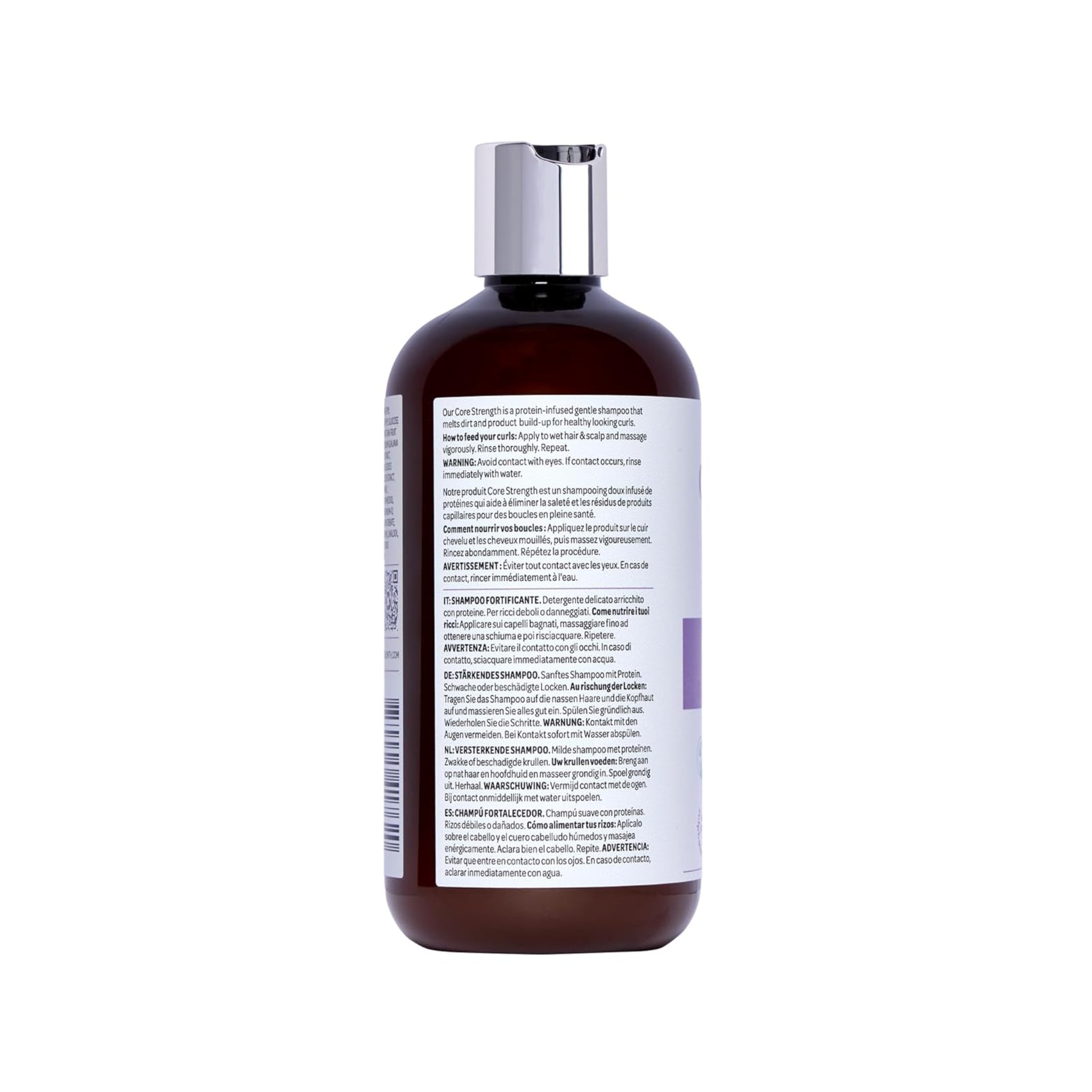 Brun plastflaske med sølvlåg af Core Strength shampoo med etiket i flersprogede brugsanvisninger.