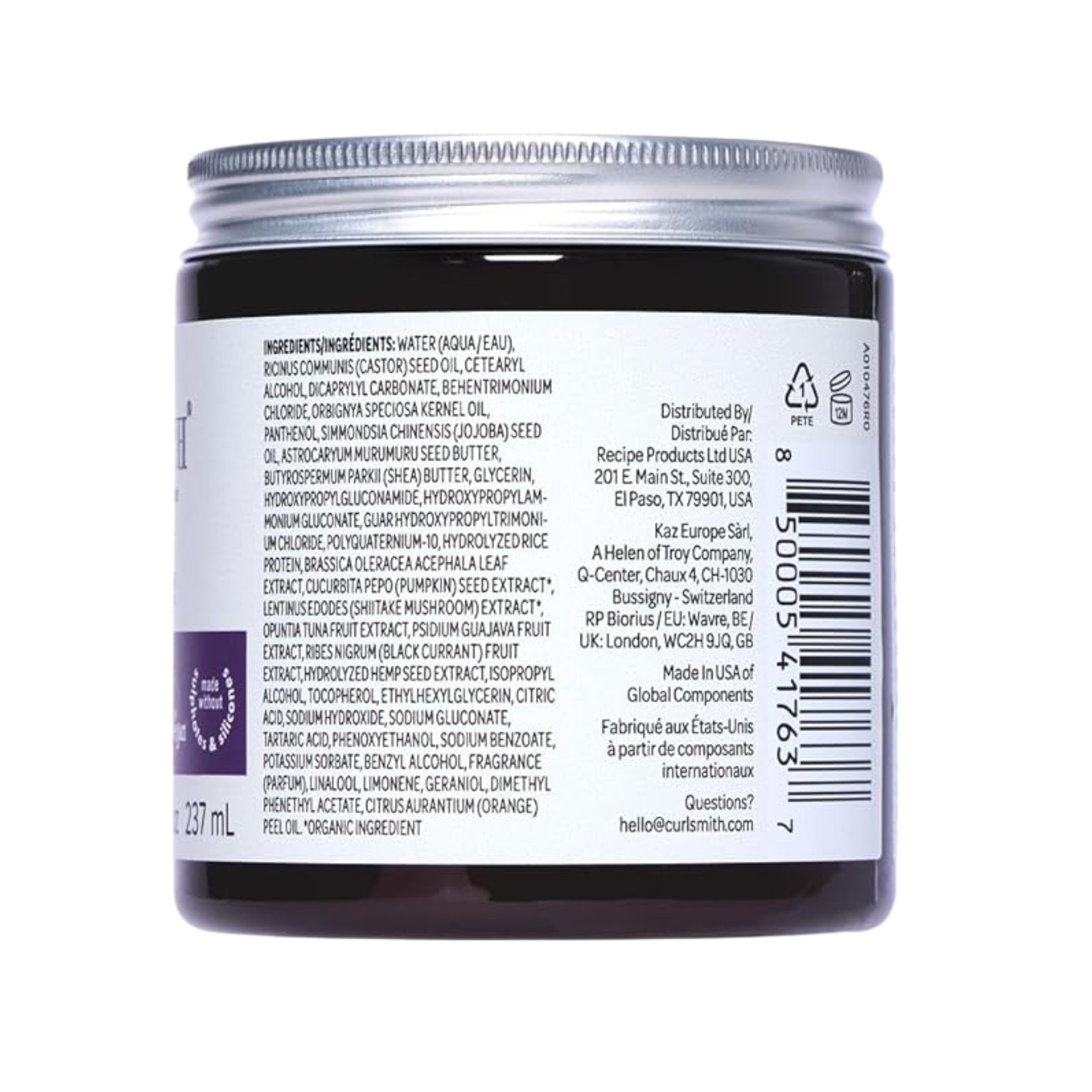 Curlsmith hårprodukt i mørk glaskrukke med sølvlåg, ingredienslisten synlig på den hvide etiket.