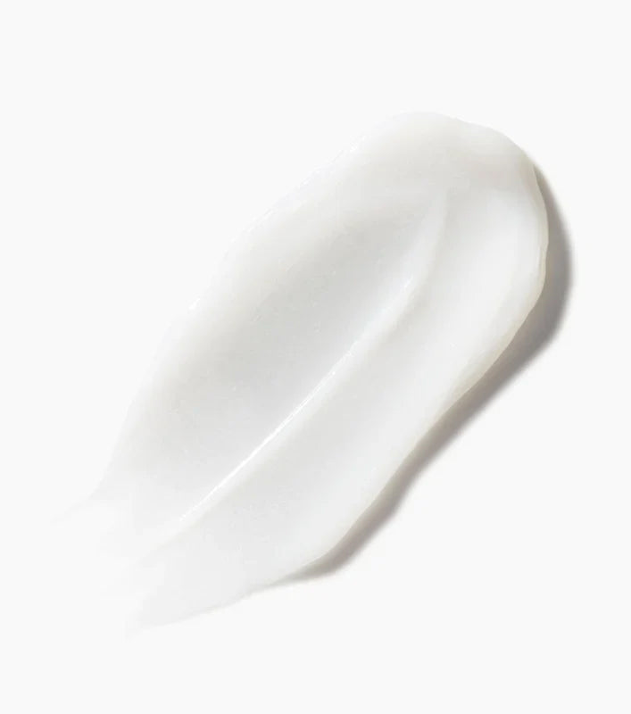 Nærbillede af en cremet, hvid balsamklat fra Not Your Mother's Naturals Blue Sea Kale & Pure Coconut Water Conditioner på en hvid baggrund.