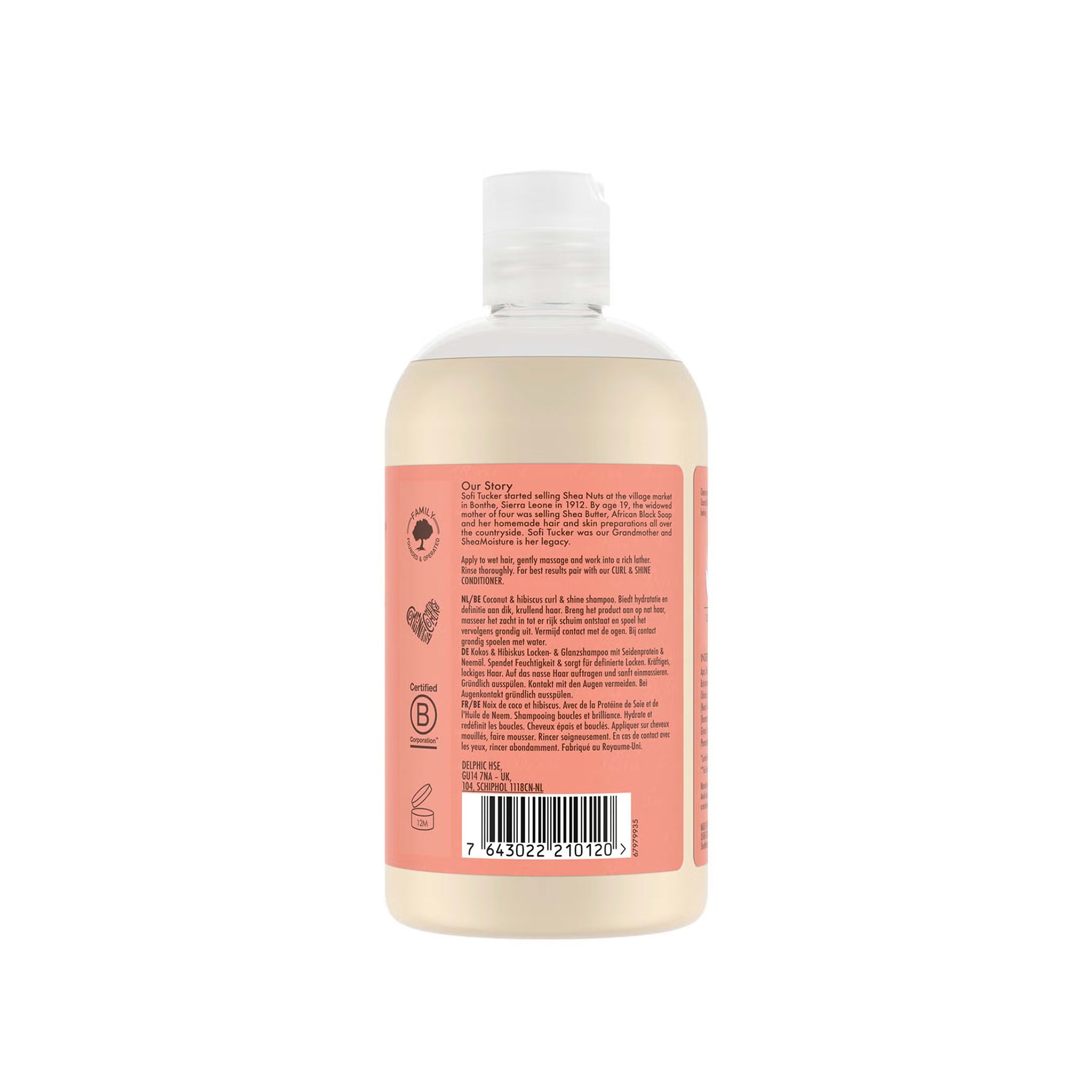 Bagsiden af en gennemsigtig flaske med Shea Moisture Coconut & Hibiscus Curl & Shine Conditioner (384 ml), der viser brandets historie, brugsanvisning, flersproget produktbeskrivelse og certificeringer.
